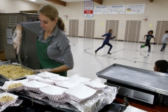 Barbara Seny portions noodles for hot lunch while students play Dodgeball in the Canterbury Elementary School gymnasium on Oct. 11. Creating a separate cafeteria, adding two classrooms and relocating the school's main office and main entrance is part of the Greendale School District's $33.8 million referendum on the Nov. 6 ballot.