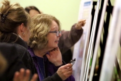 Visitors to the a public open house on the draft of the Life Sciences District Master Plan wade through a sea of displays explaining various aspects of the development proposal.