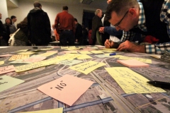 Visitors to the public open house on the draft of the Life Sciences District Master Plan for lands remaining in the former County Ground property leave comments on an aerial photograph of the area.