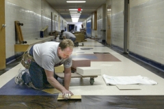 nb 0825 schools1 raw ct m9.75 x 3.8Steve Gasper and other Handeland Flooring employees lay new floor tile in the New Berlin West High School corridor near the cafeteria as part of the on-going school renovation project.