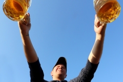 Russell Miller feels the burn, or bier, in a round of Masskrugstemmen, a German endurance game,  during Elm Grove's Oktoberfest hosted by the Elm Grove Foundation at Village Park on Sept. 23.