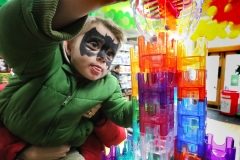 With a boost from his mother Elizabeth, James Davis of New Berlin adds steel balls to the top for a trip through a Q Ba Maze tower at Silly Willyz Toy Shop on Nov. 11 as one of the stores nation wide celebrating National Neighborhood Toy Store Day. Families were invited to try a variety of toys, do arts and crafts, and receive a creation by Love Bug Face Painting.