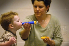 bk 0202 moms3 raw ct m7.8 x 4.8Ben Hoppenjan, 3, blew a stream of fine soap bubbles with a bit of help from his mom, Aimee Hoppenjan, during a Jan. 27 play session of Moms and More in the St. John Vianney Church hall.