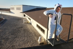 Ronald Reagan Elementary Principal Brady Reinke climbs onto a rooftop section wearing an abominable snowman suit he wore for the school's pajama day to get ready for spending the night of Nov. 30 on the roof that was an incentive for students to raise $25,000 in a school fundraiser.