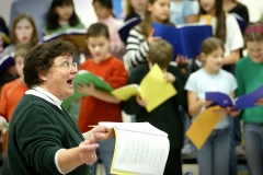 bk 0202 play2 raw ct m5.8 x 4.2Katie Bart, Burleigh's vocal music instructor and director for "Tunes 'n Tales," leads a third of the 210 member cast through a vocal rehearsal.