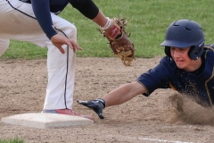 Brookfield Academy's Joey Krantz is swept back at first by Lake Country Lutheran's Tyler Brandenburg at Lake Country Lutheran on May 8.